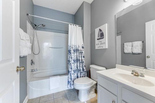a bathroom with a white toilet and a sink at North Myrtle Beach Condo Rental with Pool Access! in North Myrtle Beach