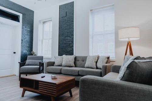 a living room with a couch and a table at Luxe 2BR Oasis Patio & Laundry Soulard in Soulard