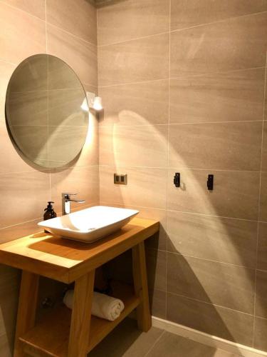 a bathroom with a sink and a mirror at Calma Cabins in Puerto Clocker