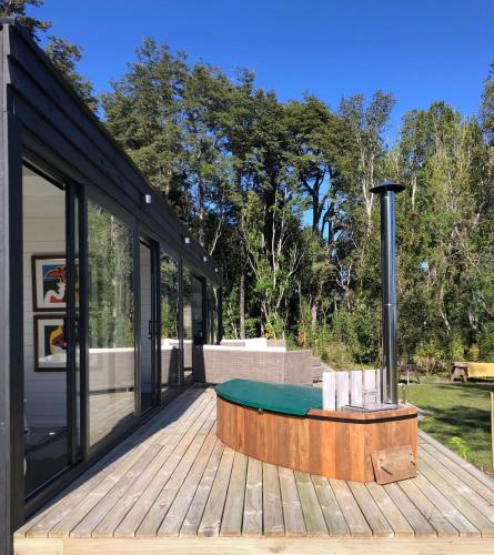 a house with a pool table on a deck at Calma Cabins in Puerto Clocker