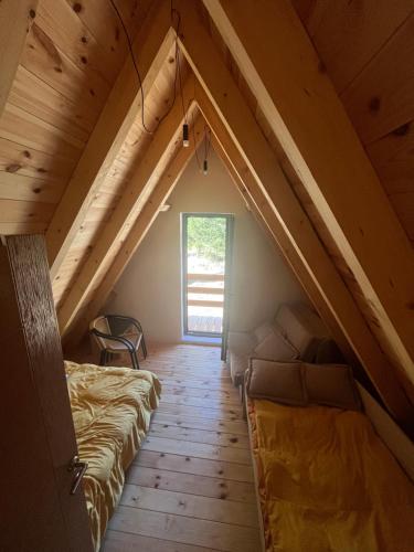 Zimmer im Dachgeschoss mit 2 Betten und einem Fenster in der Unterkunft Eden in Žabljak