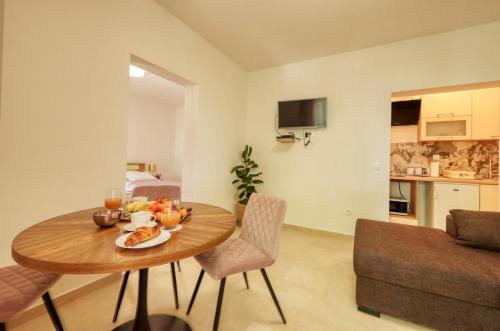 a living room with a table with fruit on it at Ardura shimmering on the sea in Mlini