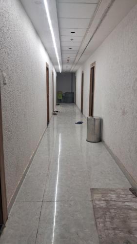 an empty hallway of an office building with a long corridor at Laxman Guest House varanasi in Varanasi
