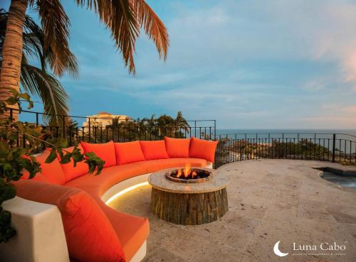 a couch sitting on a patio with a fire pit at Firepit Sunsets, Hot Tub Soaks, BBQ, Ocean Views in San José del Cabo