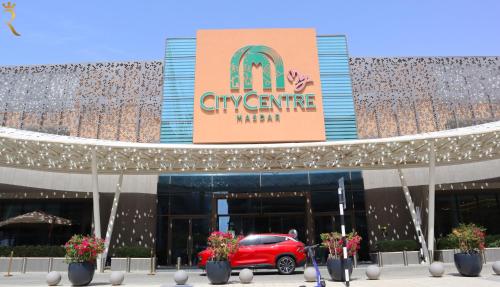 a car parked in front of a mcdonalds building at Chalet Blissful - Serene 2BR Duplex Stay in Oasis, Near Masdar Park in Abu Dhabi