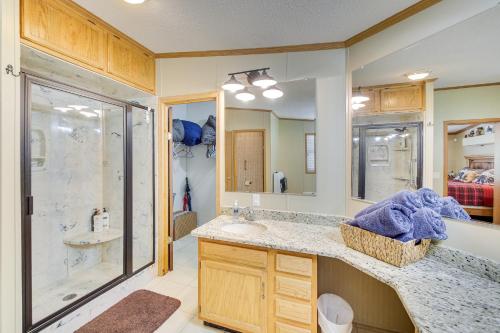a bathroom with a shower and a sink and a mirror at Lakefront Arkansas Home with Dock and Sunroom in Hot Springs