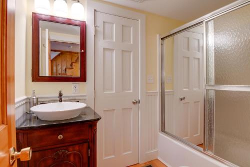 a bathroom with a sink and a glass shower at North Conway Home Less Than Walk to Slopes at Cranmore! in North Conway