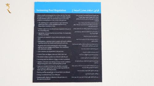 a poster of a document on a wall at Chalet Blissful - Serene 2BR Duplex Stay in Oasis, Near Masdar Park in Abu Dhabi