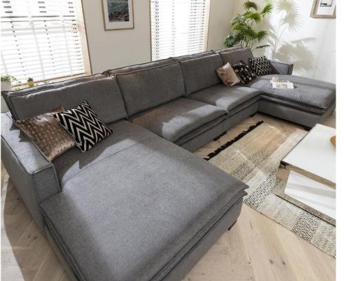 a grey leather couch in a living room at House in the middle of Malmö in Malmö