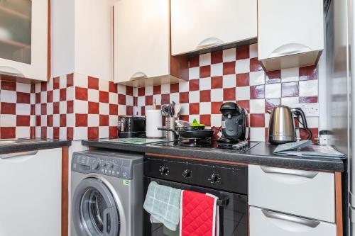 a kitchen with a stove and a washing machine at Holywell Rise Swords in Swords