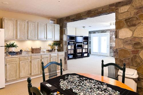 a kitchen with a table and a stone wall at Sunset Cove in Maynardville