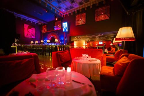 a restaurant with red chairs and tables in a room at La Suite Hotel-Adults friendly 16 Years plus in Agadir