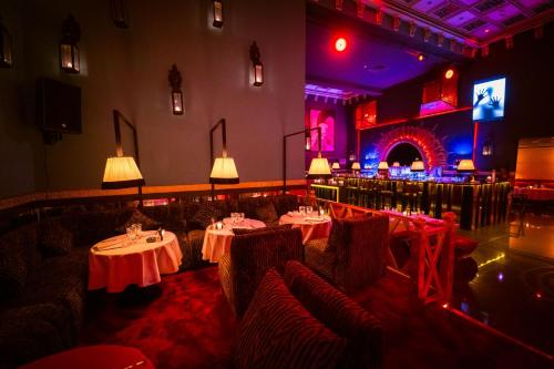 a restaurant with tables and chairs in a room at La Suite Hotel Agadir Adults Only in Agadir