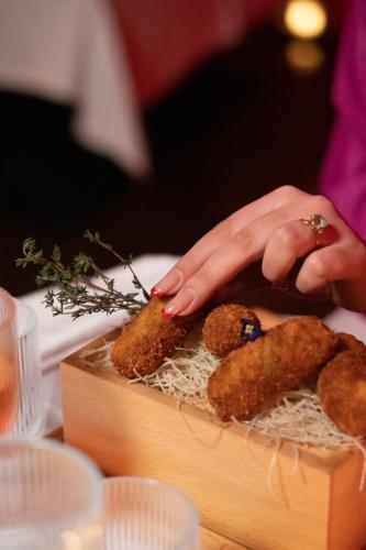 a person with their hand on a box with two teddy bears at La Suite Hotel Agadir Adults Only in Agadir