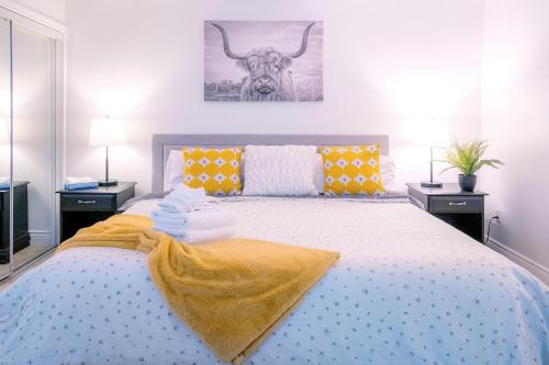 a bedroom with a bed with a cow on the wall at Gorgeous Studio Condo in Blue Mountains Sleeps 4 in Blue Mountains