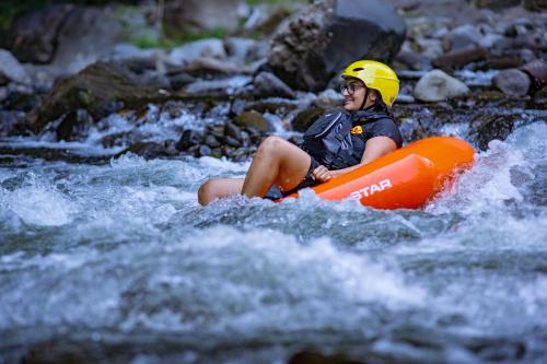 a person in an orange raft in a river at Hacienda Los Molinos Boutique Hotel & Villas in Boquete