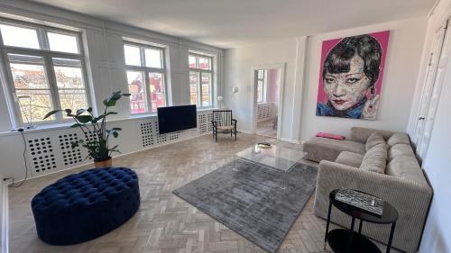 a living room with a couch and a tv at The Square - Apartments 1 & 2 - Carolinas Apartment in Copenhagen