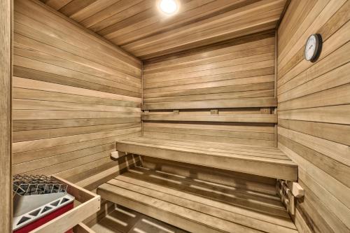 a wooden sauna with benches and a clock in it at Lakeland Village 406 - The Lake Escape in South Lake Tahoe