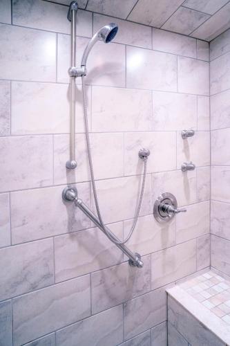 a shower with a shower head in a bathroom at Gorgeous Studio Condo in Blue Mountains Sleeps 4 in Blue Mountains