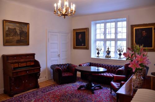 a living room with a couch and a table and a window at Rent a Room Copenhagen in Copenhagen