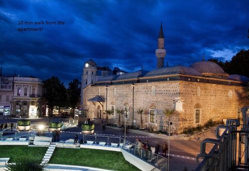 a large building with a mosque in the background at Trakia Street Apartment in Plovdiv