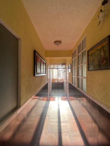 um corredor de um edifício com pinturas nas paredes em grape apartments em Kathmandu