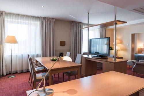 a hotel room with a table and a television at Scandic Gdańsk in Gdańsk