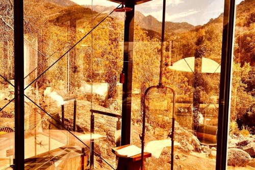 a glass room with a view of a mountain at Paradise Ranch Inn- Awake House Hot Tub,Sauna in Three Rivers