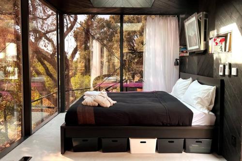 a bedroom with a bed and a large window at Paradise Ranch Inn- Awake House Hot Tub,Sauna in Three Rivers