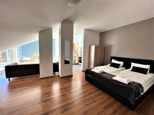a bedroom with a large bed and a large window at Local Stay Hotel, BW Signature Collection in Bansko