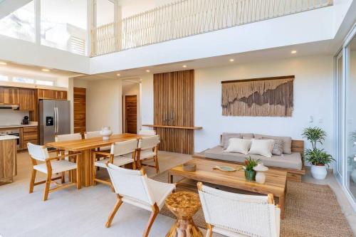 a living room with a table and a couch at Hermosa Palms, Casa Lorenzo Beach Front Club House in Playa Hermosa
