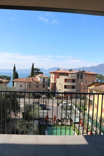 a view of a city from a balcony at Hotel Ristorante Al Caminetto WorldHotels Crafted Adults Only in Torri del Benaco