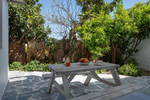 a wooden table with fruit on it on a patio at Yiamarin in Istron
