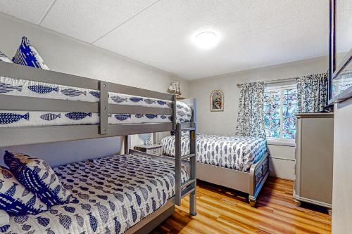 1 dormitorio con 2 literas y ventana en Assateague House 205, en Ocean City