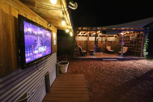 a large screen tv on the side of a building at 3 Bdrms & Private Backyard Tiki Courtyard & more in Homosassa Springs