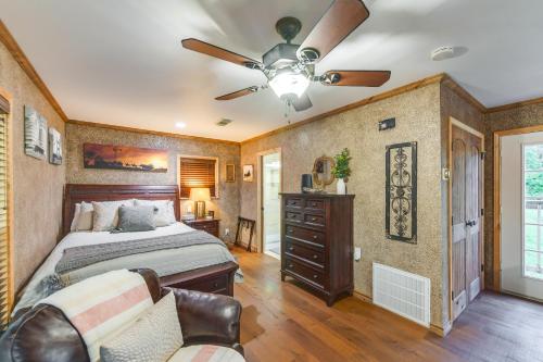 a bedroom with a bed and a ceiling fan at Rustic River Cabin with Dock and Covered Deck! in Waco