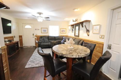 a living room with a table and chairs at 3 Bdrms & Private Backyard Tiki Courtyard & more in Homosassa Springs
