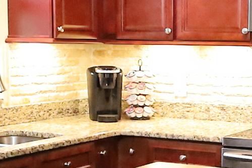 a coffee maker on a counter in a kitchen at 3 Bdrms & Private Backyard Tiki Courtyard & more in Homosassa Springs