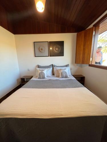 a bedroom with a large bed in a room at Paraíso Capitólio Suítes Pousada in Capitólio