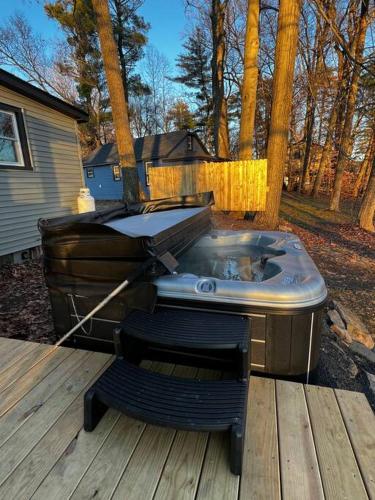 a hot tub sitting on top of a wooden deck at Esopus Creekside in Lake Katrine