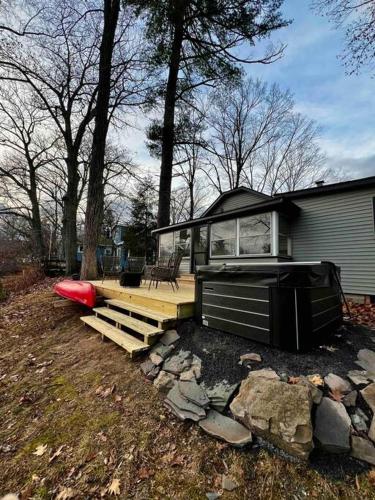 a house with a deck and a red frisbee at Esopus Creekside in Lake Katrine