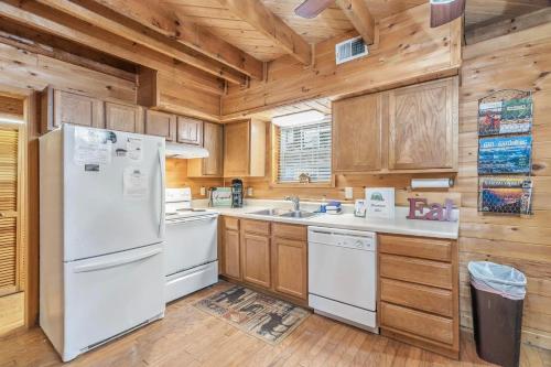 a kitchen with white appliances and wooden cabinets at Mountain Bliss in Townsend