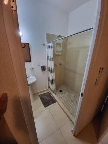 a bathroom with a shower and a toilet at Casa Espiral in Playa del Carmen