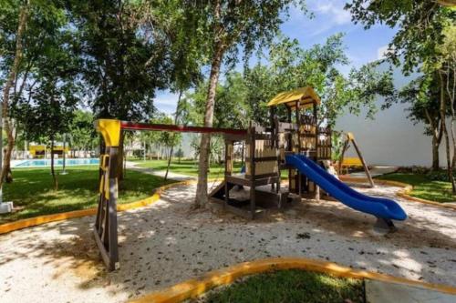 a park with a playground with a slide at Casa Espiral in Playa del Carmen