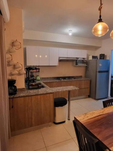 a kitchen with a counter top and a refrigerator at Casa Espiral in Playa del Carmen