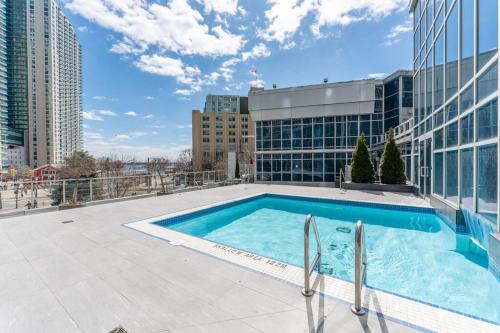 a swimming pool on the roof of a building at Toronto Views ~ Pool ~ BBQ ~ Harbourfront ~ WIFI in Toronto