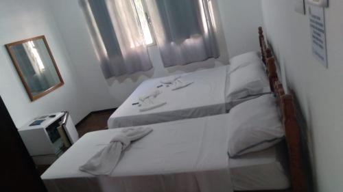Ένα ή περισσότερα κρεβάτια σε δωμάτιο στο Pousada Barão Real