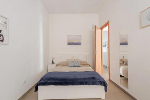 a white bedroom with a bed and a mirror at Dimora del Sole 2 - Intero Appartamento in LʼAquila