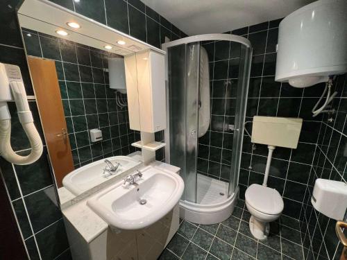 a bathroom with a sink and a toilet and a shower at Apartments with parking spaces Pag - 22601 in Pag