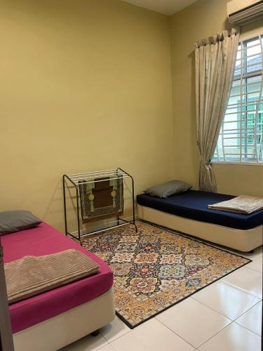 a bedroom with two beds and a window at TDH Homestay Arau FREE Wifi in Arau